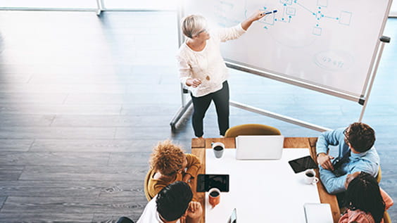 woman presents at the whiteboard